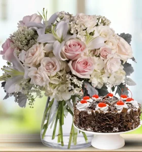 lilies-roses-alstroemeria-and-hydrangeas-in-vase-with-cake